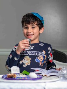 Child holding a Kiddush Cup