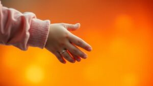 Child's hands reaching out in a supportive gesture.